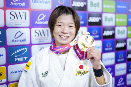 金メダルを手にしている笑顔の古賀若菜選手